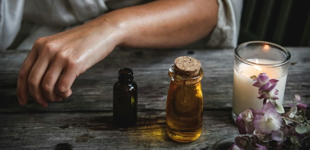 two oil tinctures and a candle